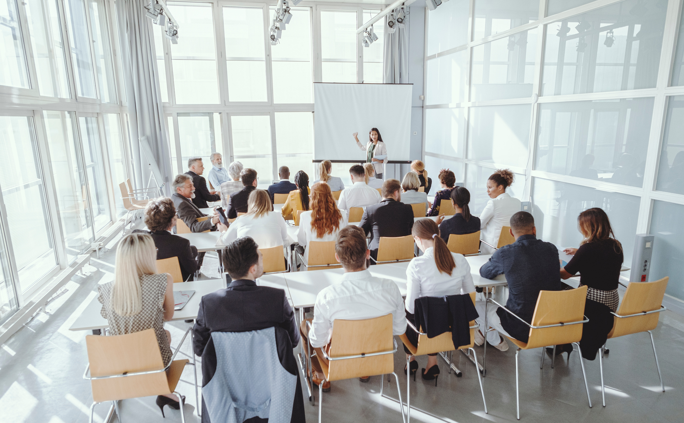 Woman Presenting to Colleagues 